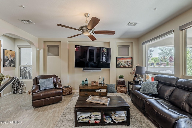 12738 W Brookhart Way, Peoria, AZ 85383 - living area with baseboards, ceiling fan, and arched walkways