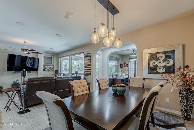 12738 W Brookhart Way, Peoria, AZ 85383 - dining area with a ceiling fan, arched walkways, light tile patterned floors, and baseboards