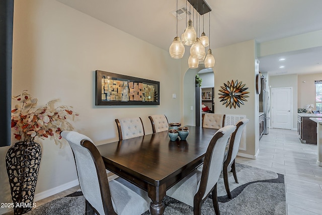 12738 W Brookhart Way, Peoria, AZ 85383 - dining space featuring arched walkways, a chandelier, baseboards, light tile patterned flooring, and recessed lighting