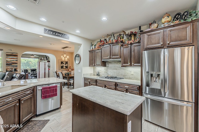 12738 W Brookhart Way, Peoria, AZ 85383 - kitchen with stainless steel appliances, arched walkways, recessed lighting, tasteful backsplash, and a sink