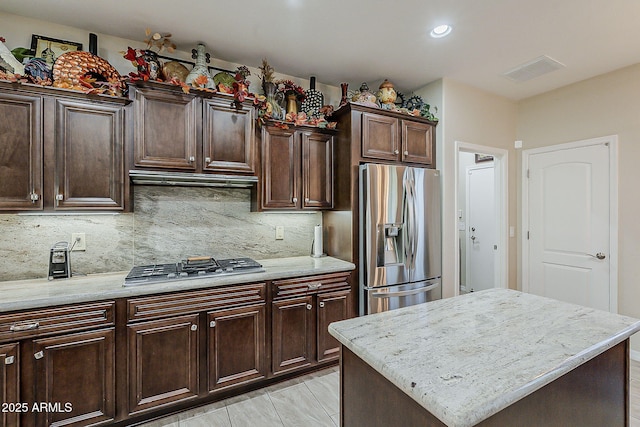 12738 W Brookhart Way, Peoria, AZ 85383 - kitchen featuring appliances with stainless steel finishes, tasteful backsplash, dark brown cabinetry, recessed lighting, and light stone counters