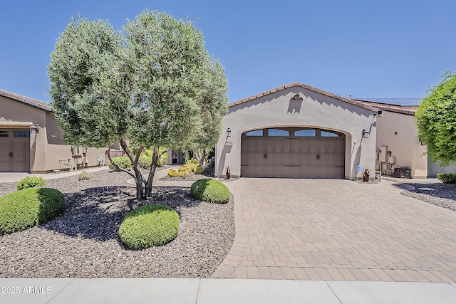 12738 W Brookhart Way, Peoria, AZ 85383 - mediterranean / spanish-style house with a garage, stucco siding, and decorative driveway