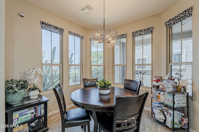 12738 W Brookhart Way, Peoria, AZ 85383 - dining space with healthy amount of natural light, baseboards, a chandelier, and light wood finished floors