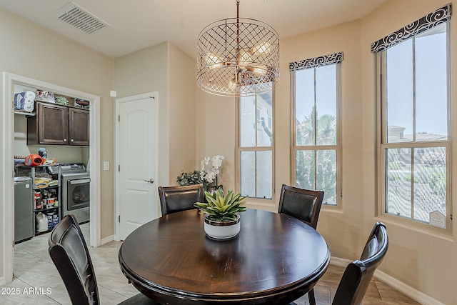12738 W Brookhart Way, Peoria, AZ 85383 - dining area featuring washer and dryer, baseboards, and light tile patterned floors