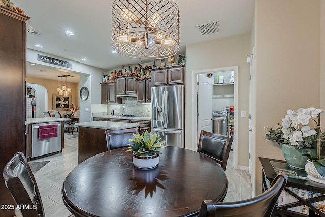 12738 W Brookhart Way, Peoria, AZ 85383 - dining area featuring a chandelier, recessed lighting, baseboards, and arched walkways