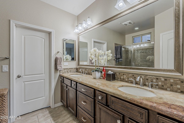 12738 W Brookhart Way, Peoria, AZ 85383 - bathroom featuring decorative backsplash, double vanity, and a stall shower