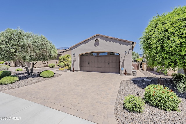 12738 W Brookhart Way, Peoria, AZ 85383 - mediterranean / spanish-style home featuring decorative driveway, stucco siding, and an attached garage