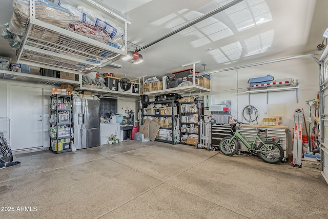 12738 W Brookhart Way, Peoria, AZ 85383 - garage featuring a garage door opener, stainless steel fridge with ice dispenser, and a workshop area