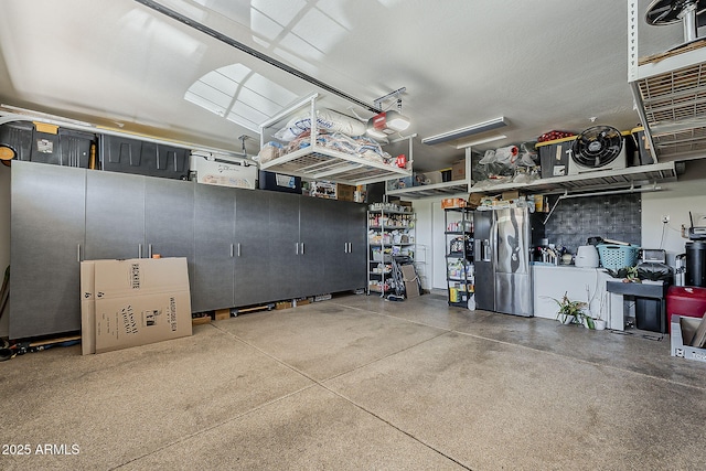 12738 W Brookhart Way, Peoria, AZ 85383 - garage with stainless steel fridge and a garage door opener