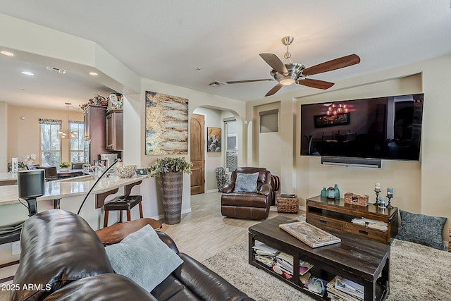 12738 W Brookhart Way, Peoria, AZ 85383 - living room featuring arched walkways, recessed lighting, a ceiling fan, and baseboards