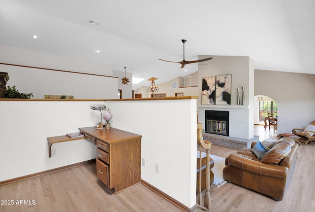 1338 W Mountain View Dr, Mesa, AZ 85201 - living area featuring light wood finished floors, vaulted ceiling, arched walkways, recessed lighting, and baseboards