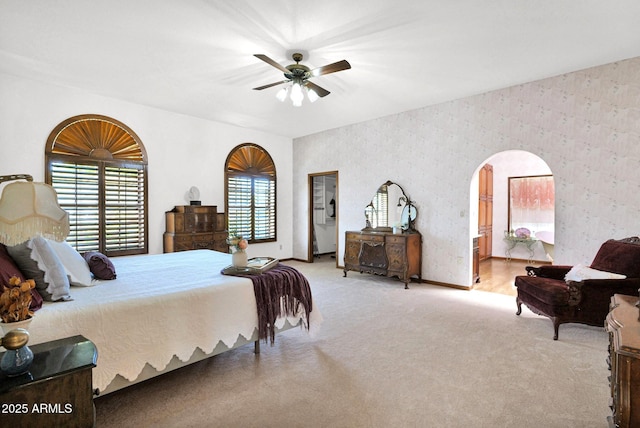 1338 W Mountain View Dr, Mesa, AZ 85201 - carpeted bedroom featuring wallpapered walls, baseboards, arched walkways, and ceiling fan