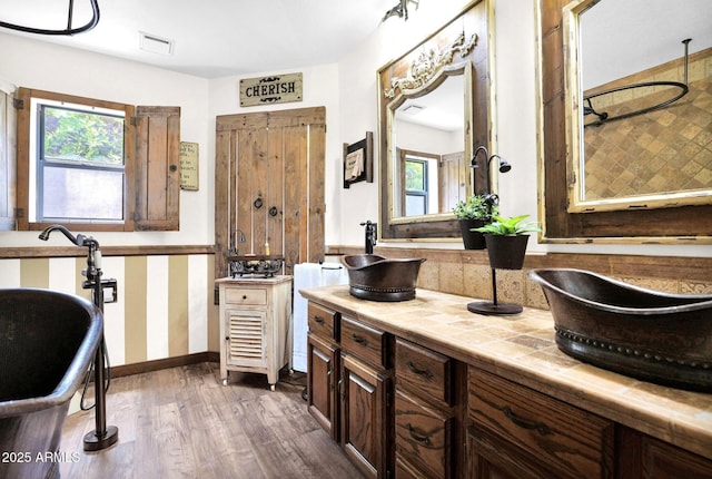 1338 W Mountain View Dr, Mesa, AZ 85201 - full bathroom with wood finished floors, healthy amount of natural light, a freestanding tub, and baseboards