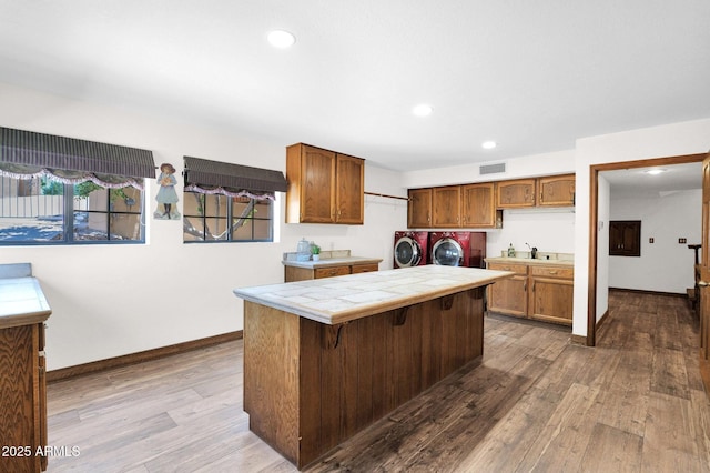 1338 W Mountain View Dr, Mesa, AZ 85201 - kitchen featuring tile countertops, independent washer and dryer, dark wood-type flooring, recessed lighting, and a sink