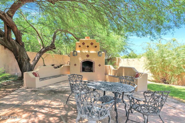 1338 W Mountain View Dr, Mesa, AZ 85201 - view of patio / terrace with exterior fireplace and outdoor dining space