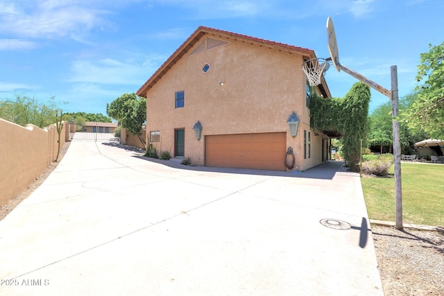 1338 W Mountain View Dr, Mesa, AZ 85201 - view of side of property with stucco siding, driveway, and an attached garage
