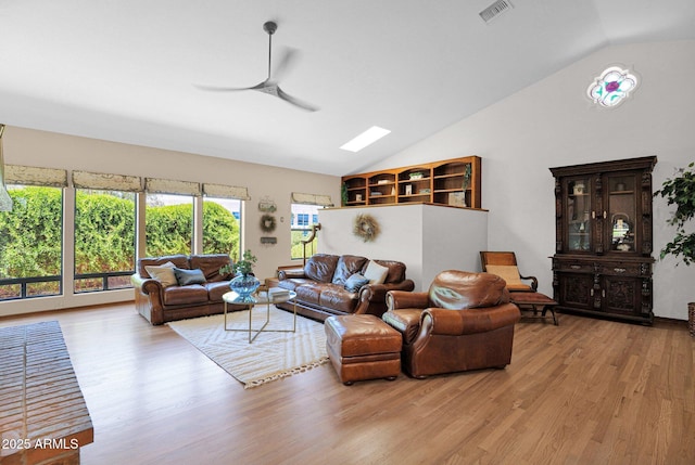 1338 W Mountain View Dr, Mesa, AZ 85201 - living room featuring light wood-style flooring, a ceiling fan, high vaulted ceiling, and a skylight