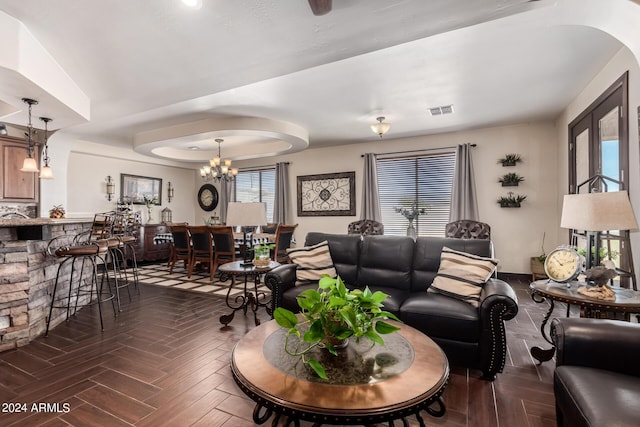 living room featuring an inviting chandelier and dark parquet floors