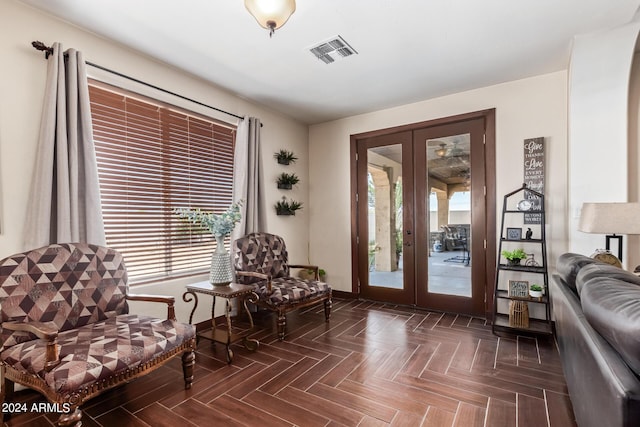 sitting room featuring dark parquet floors and french doors