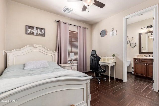 bedroom featuring dark parquet flooring, sink, connected bathroom, and ceiling fan