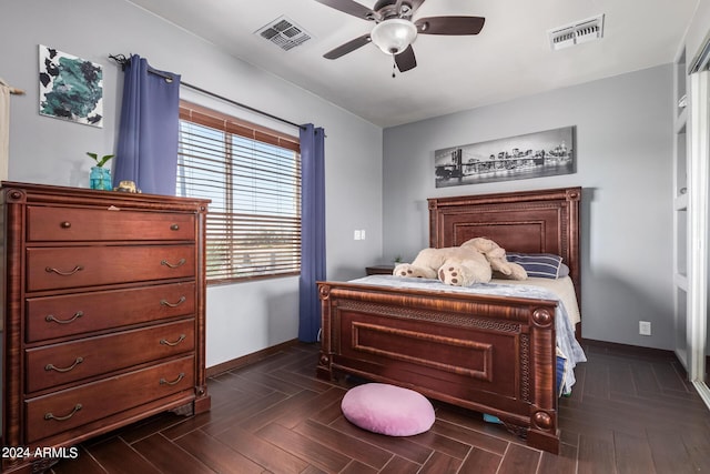 bedroom with ceiling fan and dark parquet floors