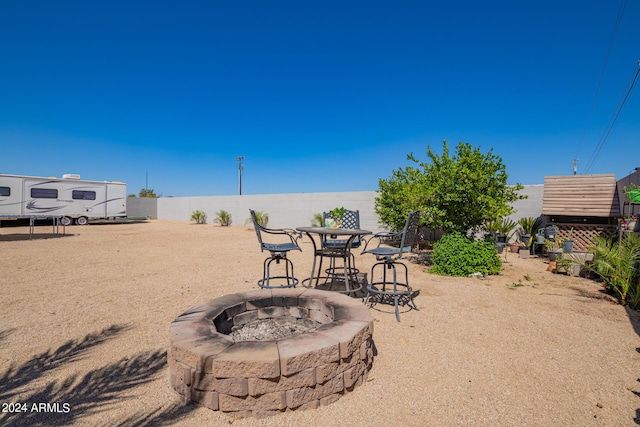 view of yard with a fire pit