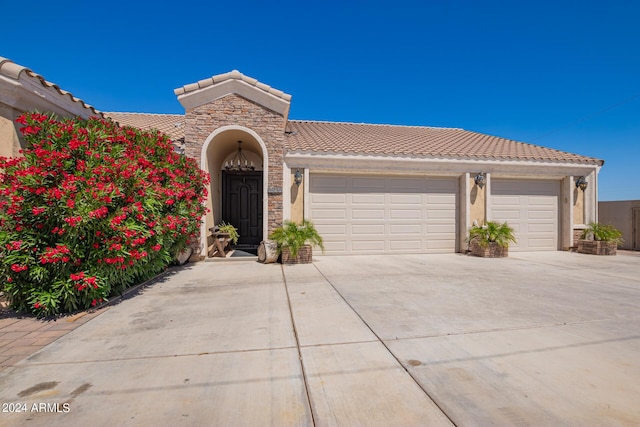 mediterranean / spanish-style home featuring a garage