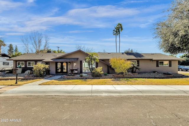 ranch-style house featuring french doors