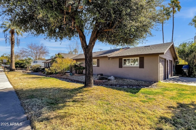 view of front of house featuring a garage and a front lawn