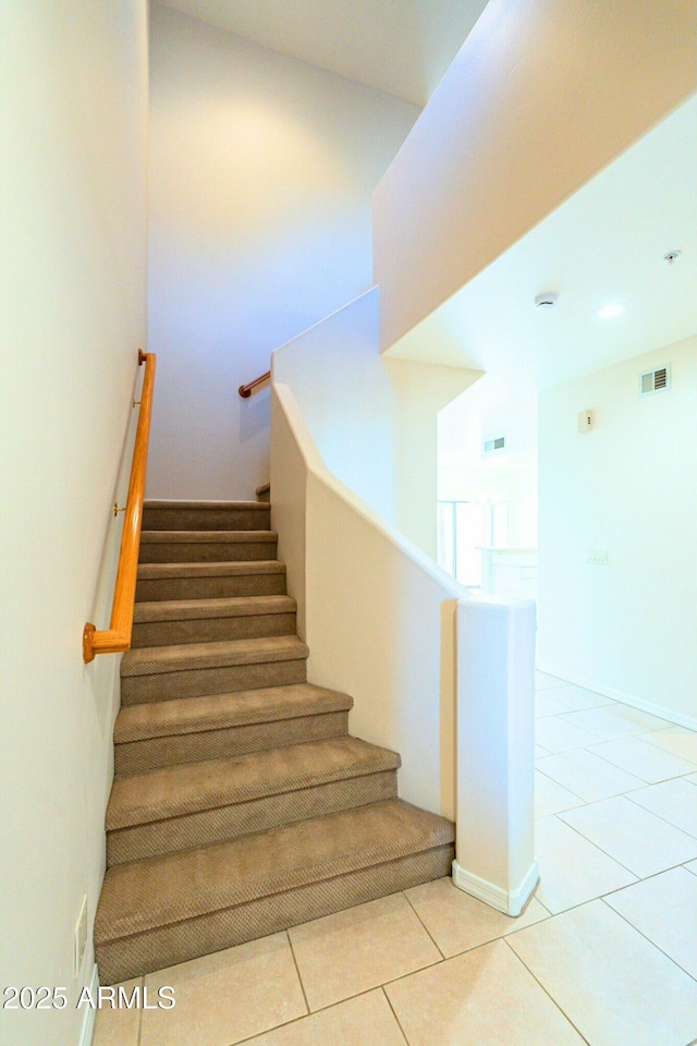 stairway with tile patterned flooring