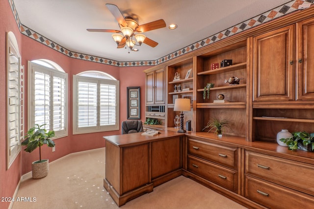 office with light carpet and ceiling fan