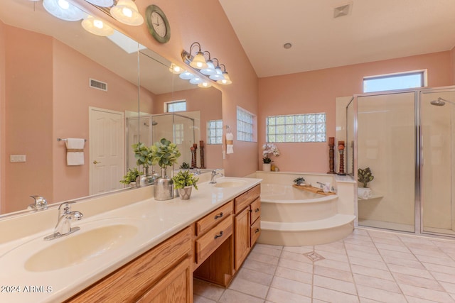 bathroom with tile patterned flooring, plenty of natural light, vanity, and plus walk in shower