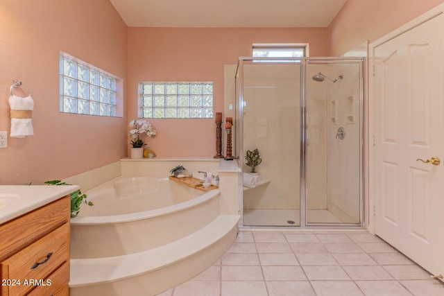 bathroom with tile patterned flooring, shower with separate bathtub, and vanity