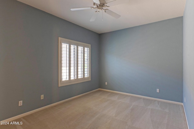 unfurnished room with ceiling fan and light colored carpet