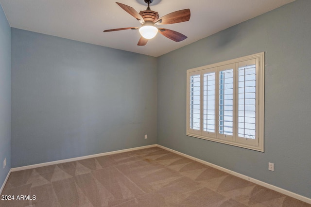 empty room featuring light carpet and ceiling fan