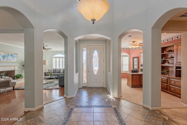 carpeted foyer entrance featuring plenty of natural light