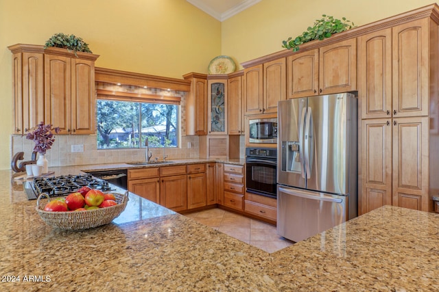 kitchen featuring light stone countertops, sink, high vaulted ceiling, and black appliances