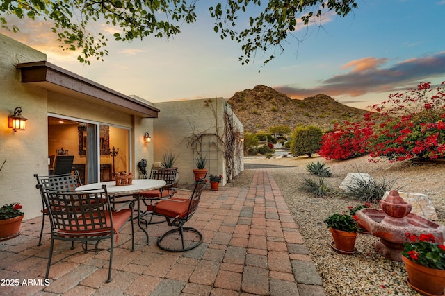 view of patio / terrace with outdoor dining area and a mountain view