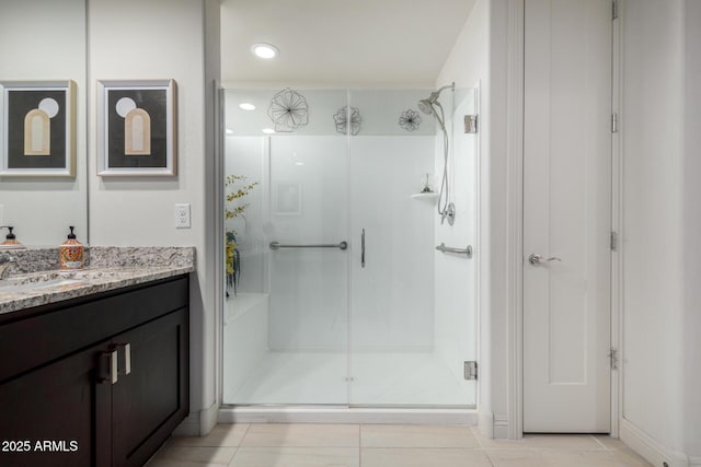 bathroom with vanity, tile patterned flooring, and a shower with shower door