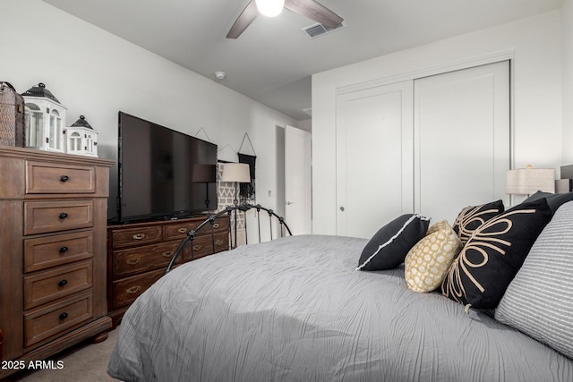 carpeted bedroom with a closet and ceiling fan