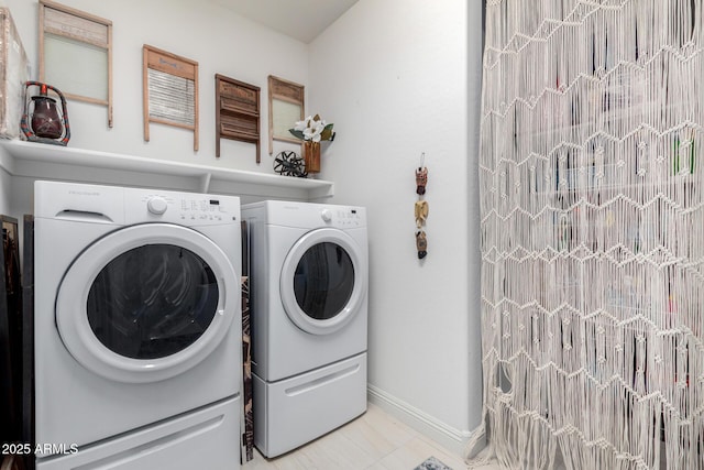 clothes washing area with separate washer and dryer