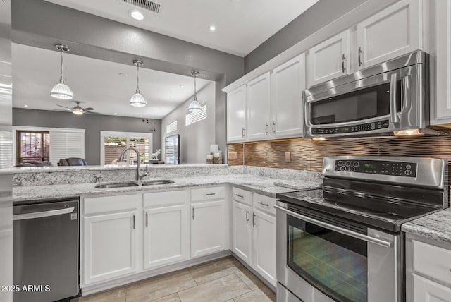 kitchen featuring stainless steel appliances, ceiling fan, a sink, white cabinetry, and visible vents