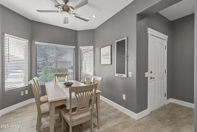 dining space with baseboards, ceiling fan, and plenty of natural light
