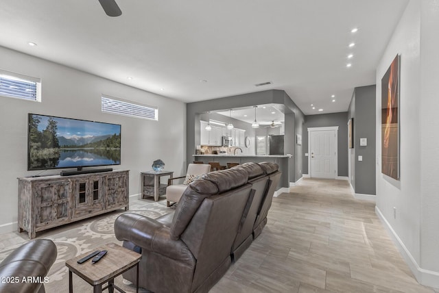 living area featuring visible vents, recessed lighting, and baseboards