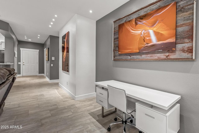 office space featuring baseboards, recessed lighting, and light wood-style floors
