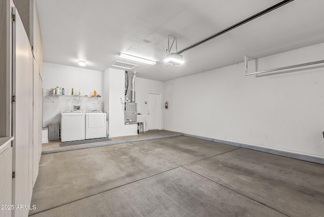 garage with washing machine and dryer, heating unit, and a garage door opener