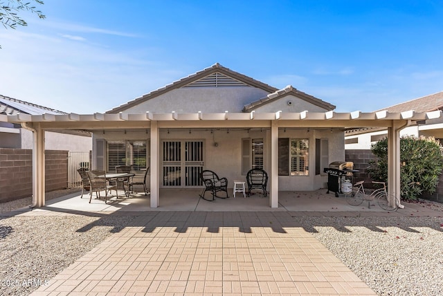 back of house featuring fence, a patio, a tiled roof, a pergola, and stucco siding
