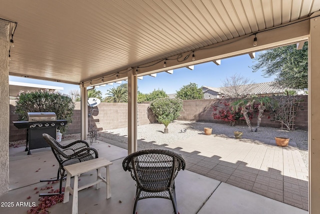 view of patio with a fenced backyard and a grill