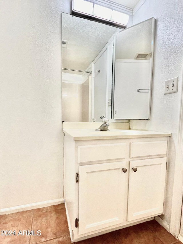 bathroom with vanity, tile patterned floors, and a textured ceiling