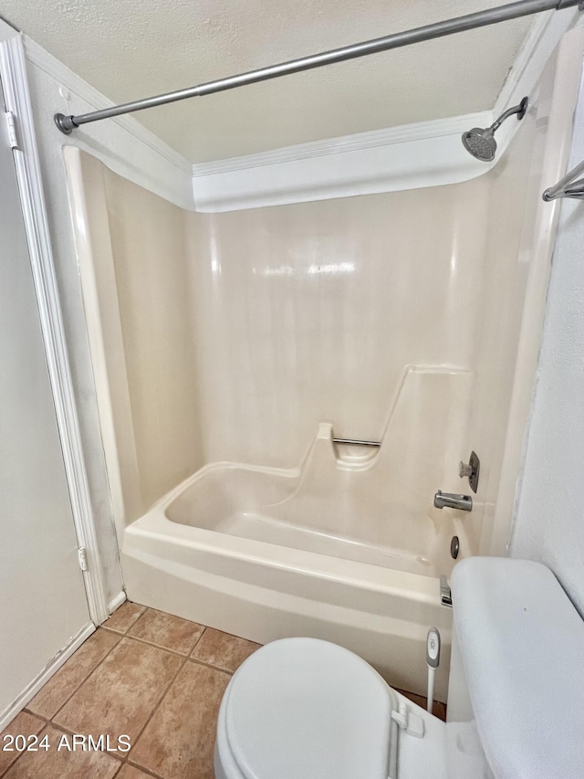 bathroom featuring tile patterned flooring, shower / bath combination, a textured ceiling, and toilet